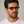 Cord Eco Ash square sunglasses with green mirror lenses worn by male model in his 30s, close-up studio portrait styled with white cotton T-shirt.