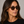Cord Eco Spotted Havana square sunglasses with tobacco lenses worn by female model in her 30s, close-up studio portrait styled with a black T-shirt, highlighting the patterned eco-acetate frame and defined, contemporary silhouette.