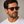 Denim Eco Havana square sunglasses with bottle green lenses worn by male model in his 30s, close-up studio portrait styled with white cotton T-shirt.