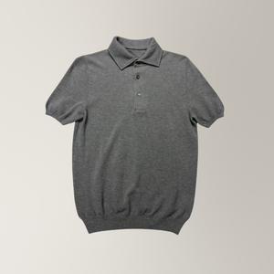 Grey marl piqué knit polo with ribbed cuffs and mother of pearl buttons.