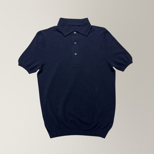 Navy knitted cotton polo featuring piqué knit, ribbed cuffs, and mother of pearl buttons.