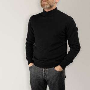 Black mock neck jumper made from 100% merino wool. Featuring a sleek mock neck and ribbed detailing on the neck, cuffs, and hem for a refined, tailored fit. 