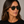 Panama Eco Dark Havana square sunglasses with bottle green lenses worn by female model in her 30s, close-up studio portrait styled with a black T-shirt, highlighting the deep-toned eco-acetate frame and clean, structured silhouette.